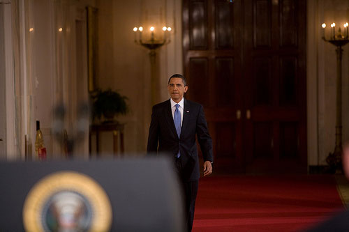 President Barack Obama walking to a prime time press conference.