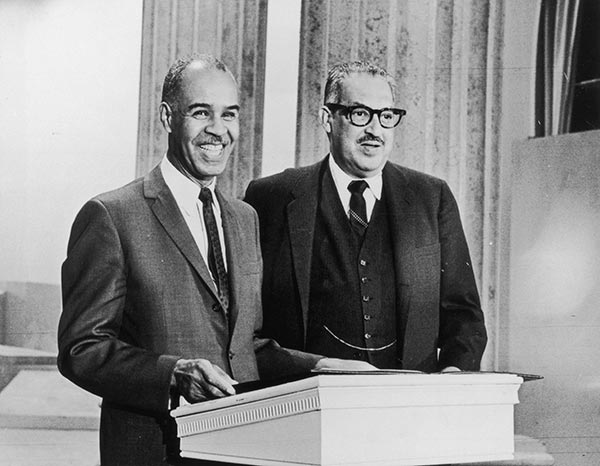 NAACP chief Executive Roy Wilkins presents the Freedom Bell Award to Judge Thurgood Marshall.